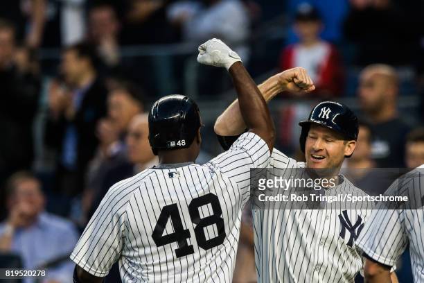 Chris Carter of the New York Yankees fist bumps Gary Sanchez after hitting a home run during the game Boston Red Sox at Yankee Stadium on June 7,...