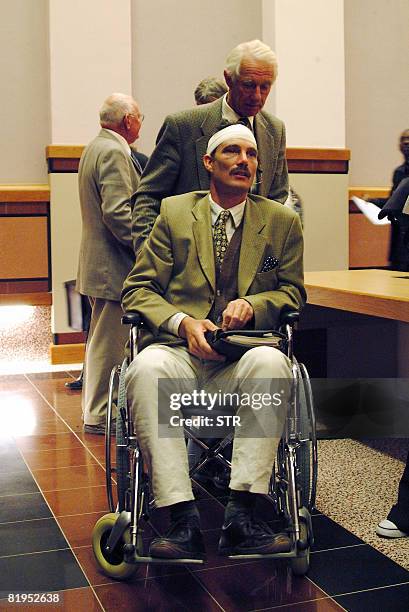 Zimbabwean farmer Ben Freeth is wheeled into the Supreme Court by his father Zach Freeth on July 16, 2008 in Windhoek. A tribunal began hearing an...