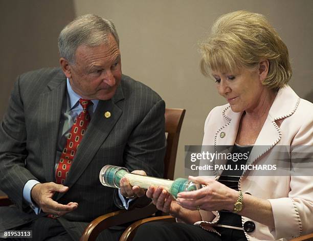 National Transportation Safety Board Chairman Mark V. Rosenker hands US Secretary of Transportation Mary E. Peters a new device commonly called a...