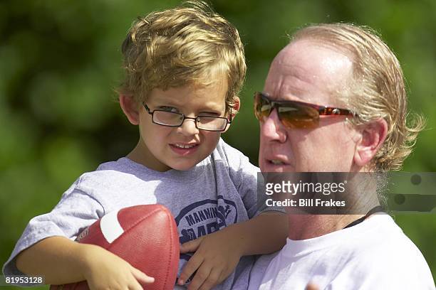 Manning Passing Academy: Closeup of former player Archie Manning with grandson during camp on Nicholls State University campus. Thibodaux, LA...