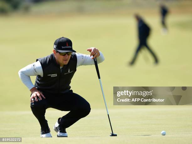 Golfer Zach Johnson lines up a putt on the 8th green during his opening round on the first day of the Open Golf Championship at Royal Birkdale golf...
