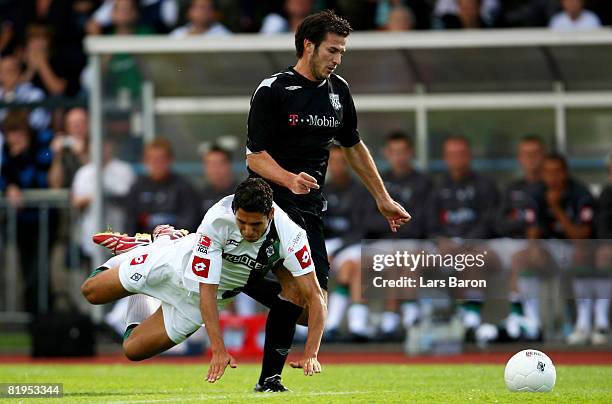 Karim Matmour of Moenchengladbach falls down next to Carl Hoefkens of Bromwich during a pre season friendly match between Borussia Moenchengladbach...