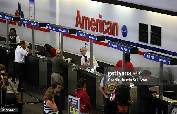 American Airlines customers wait in line to check in for flights July 16, 2008 at San Francisco International Airport in San Francisco, California....