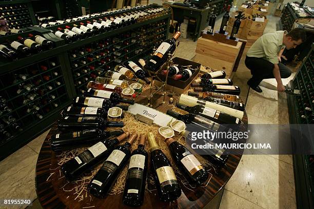 Client inspects a bottle of white wine at an imported wines' shop, in Sao Paulo, Brazil, on July 16, 2008. Brazil's currency real has reached its...