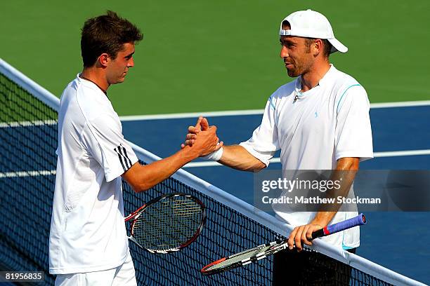 Gilles Simon of France is congratulated by Benjamin Becker of Germany after their match during the Indianapolis Tennis Championships at the...
