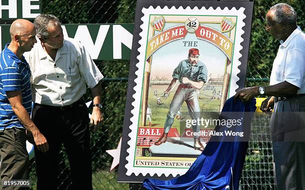 Country music singer Kenny Chesney, U.S. President George W. Bush and National Baseball Hall of Famer Frank Robinson unveil the new Take Me Out to...