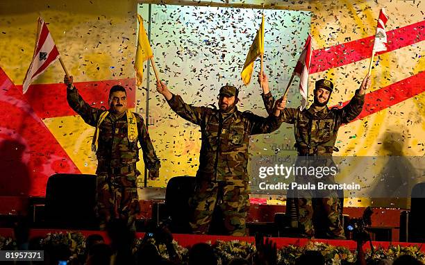 Samir Kantar and two other Lebanese prisoners freed by Israel wave to a crowd celebrating at a stadium July 16, 2008 in Beirut's southern suburbs. As...