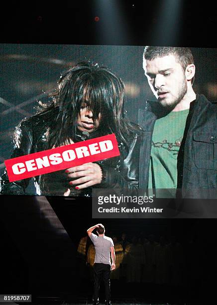 Host Justin Timberlake stands onstage in front of a video of himself and Janet Jackson from Super Bowl XXXVIII onstage at the 2008 ESPY Awards held...