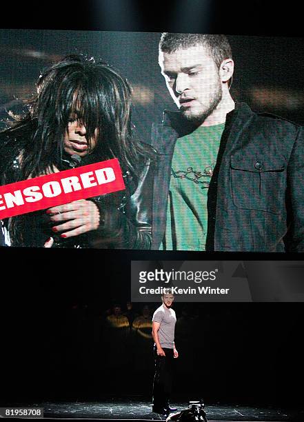 Host Justin Timberlake stands onstage in front of a video of himself and Janet Jackson from Super Bowl XXXVIII onstage at the 2008 ESPY Awards held...
