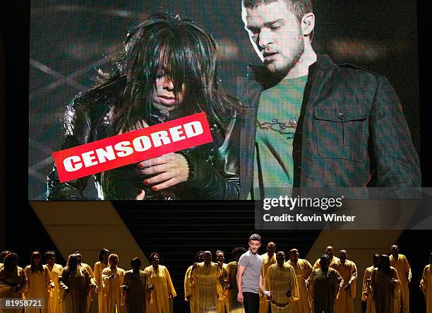 Host Justin Timberlake stands onstage in front of a video of himself and Janet Jackson from Super Bowl XXXVIII onstage at the 2008 ESPY Awards held...