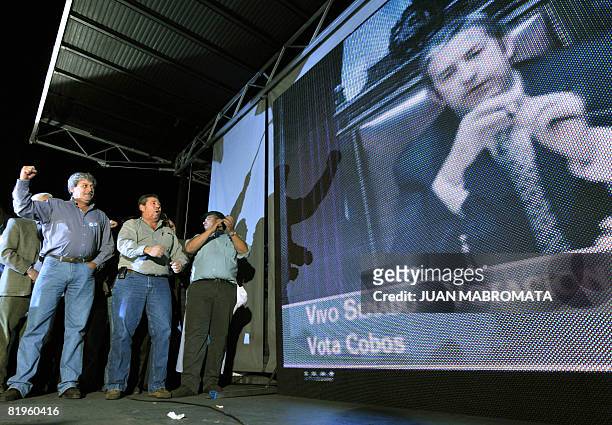 Farming leaders react next to a televised image of Argentina Vice President Julio Cobos after the Senate rejects a grain tax bill on July 17 ,2008 in...