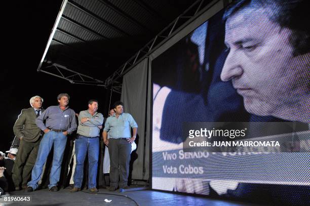 Farming leaders watch a giant screen showing a board with Argentina's Vice President Julio Cobos as the Senate votes on a controversial grain tax...