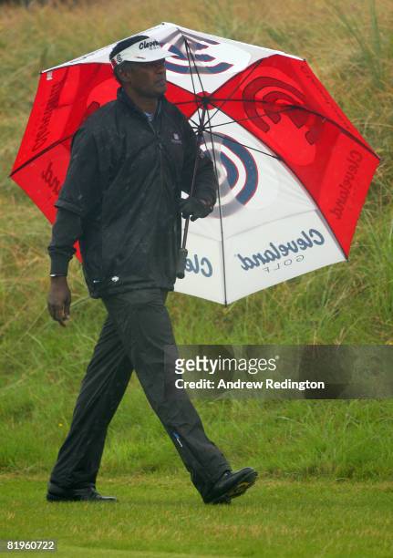 Vijay Singh of Fiji walks down the 1st hole with an umbrella during the First Round of the 137th Open Championship on July 17, 2008 at Royal Birkdale...
