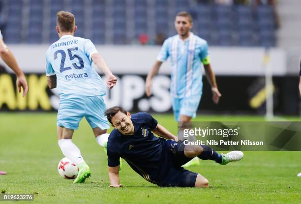 Stefan Ishizaki of AIK is tackled by Ugljea Radinovi of FK eljezniar during the UEFA Europa League qualifying match between AIK and FK Zeljeznicar at...