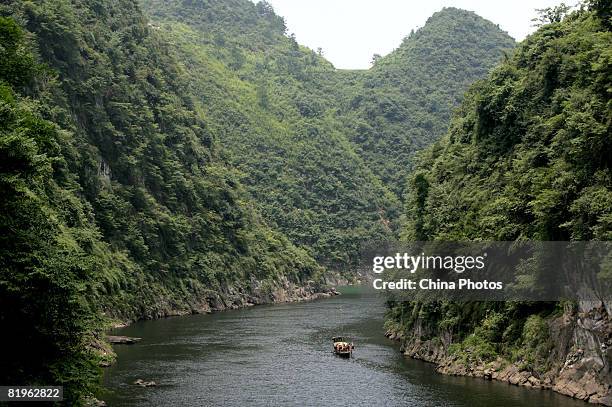 Old boatmen pole a boat along the river near the Shidi Township on July 16, 2008 in Xiushan Tujia and Miao Autonomous County of Chongqing...