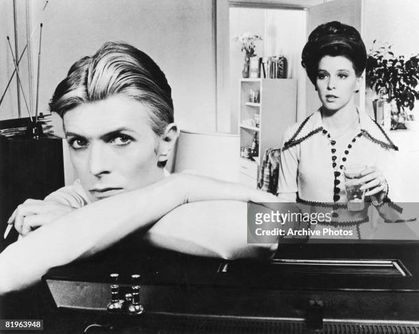 English actor, singer and musician David Bowie stars with Candy Clark in 'The Man Who Fell to Earth', 1976.