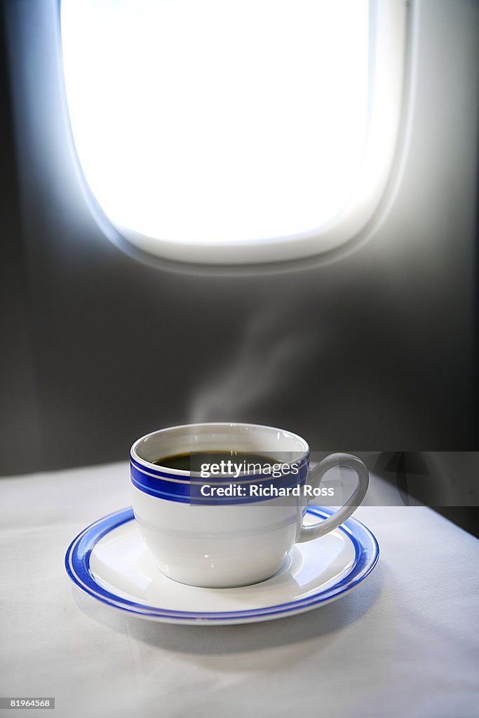 A cup of steaming coffee in first-class