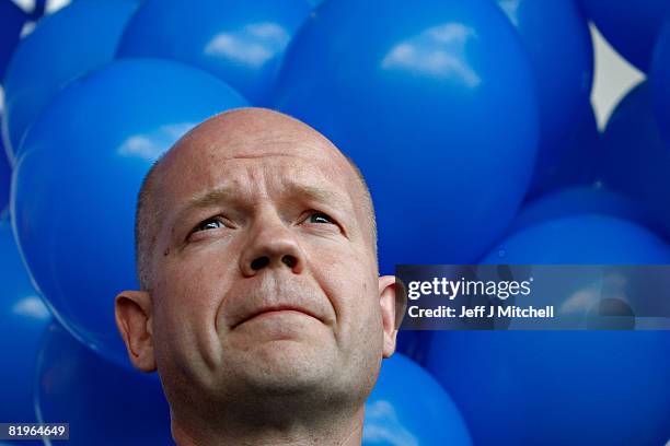 Shadow Foreign Secretary William Hague looks on during a visit to Tesco in Shettleston as he supports Davina Rankin the Conservative Party candidate...