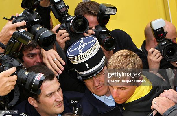 King of the mountains leader Riccardo Ricco of Italy and team Saunier Duval is taken away by two French policemen after testing postive for EPO at...