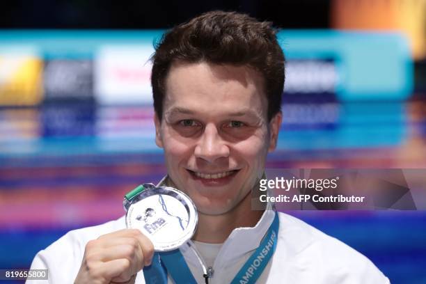 Germany's Patrick Hausding poses with his silver medal during the podium ceremony for the men's 3m springboard final during the diving competition at...