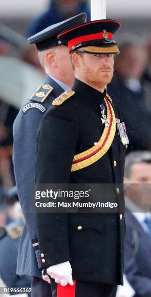 Prince Harry, on behalf of his grandmother Queen Elizabeth II, presents the RAF Regiment with a new Colour in their 75th Anniversary year at RAF...