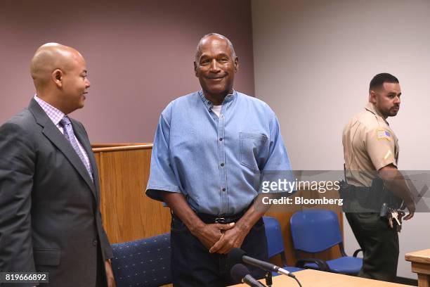 Former professional football player O.J. Simpson, center, stands during a parole hearing at Lovelock Correctional Center in Lovelock, Nevada, U.S.,...