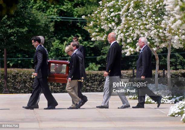 The urn containing the ashes of former White House press secretary Tony Snow is carried out of the National Shrine of the Immaculate Conception...