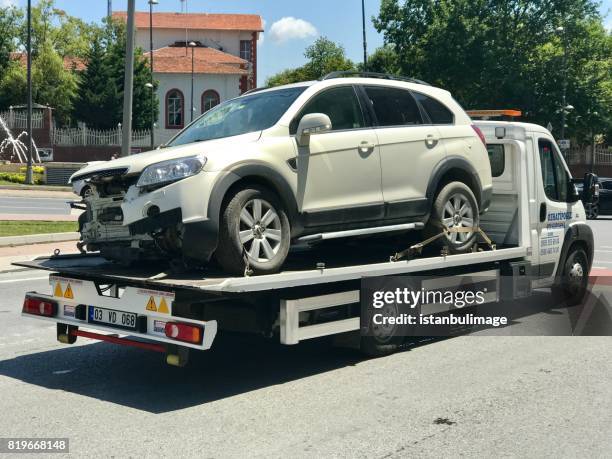 damaged car after accident on tow truck - truck and car accident stock pictures, royalty-free photos & images