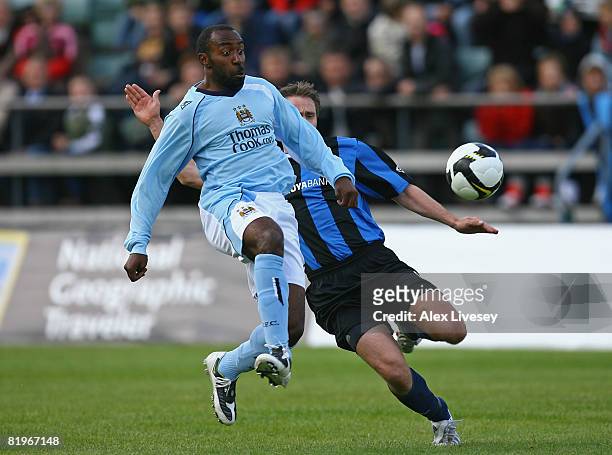 Darius Vassell of Manchester City is challenged by Frodi Clementsen of EB/Streymur during the UEFA Cup 1st Round 1st Leg Qualifying match between...