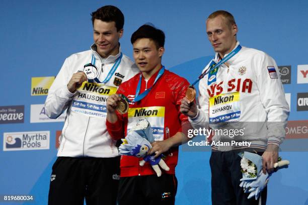 Silver medalist Patrick Hausding of Germany, gold medalist Siyi Xie of China and bronze medalist Ilia Zakharov of Russia pose with the medals won...
