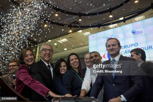 Billionaire Abilio Diniz, second left, and Charles Desmartis, chief executive officer of Grupo Carrefour Brasil, right, ring the opening bell during...