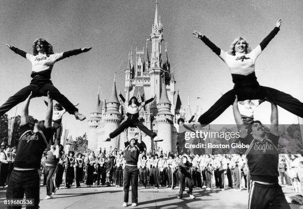 Boston College Cheerleaders along with the BC band perform out in front of the Cinderella Castle at in the Magic Kingdom at Walt Disney World in...