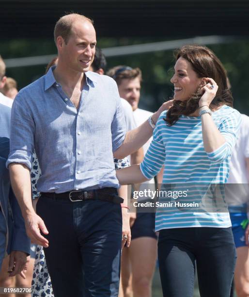 Prince William, Duke of Cambridge and Catherine, Duchess of Cambridge walk together after participating in a rowing race between the twinned town of...