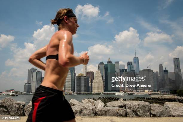 Man runs shirtless in Brooklyn Bridge Park, July 20, 2017 in the Brooklyn borough of New York City. Thursday is forecasted to be the hottest day of...