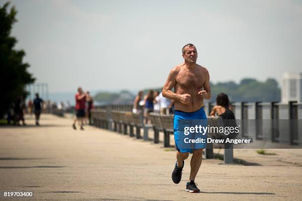 Man runs shirtless along Brooklyn Bridge Park, July 20, 2017 in the Brooklyn borough of New York City. Thursday is forecasted to be the hottest day...