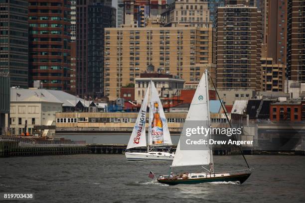 Two sailboats pass each other on the East River, July 20, 2017 in New York City. Thursday is forecasted to be the hottest day of the year so far for...