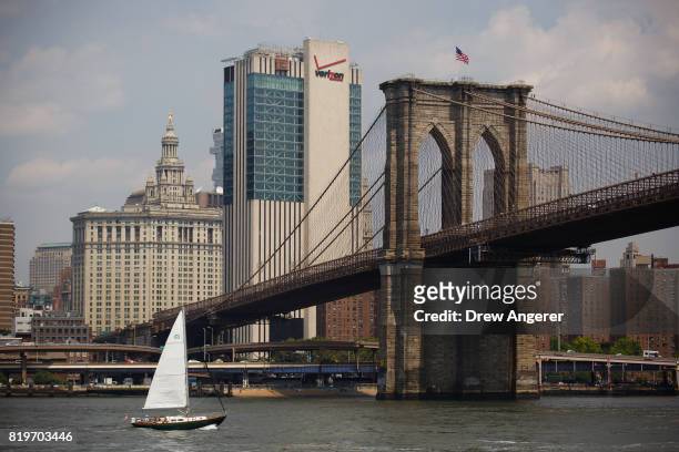 Sailboat makes it way up the East River toward the Brooklyn Bridge, July 20, 2017 in New York City. Thursday is forecasted to be the hottest day of...
