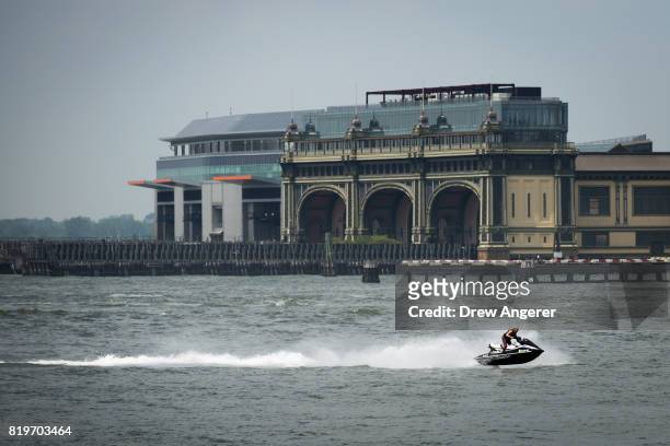 Woman rides a jet ski in the East River, July 20, 2017 in New York City. Thursday is forecasted to be the hottest day of the year so far for New York...