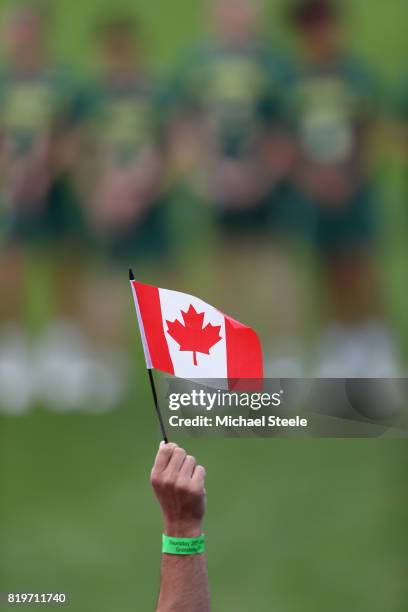 The Canadian flag is held by a spectator during the national anthems ahead of the semi-final match between Australia and Canada during the 2017 FIL...