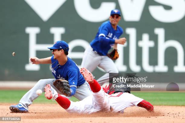 Darwin Barney of the Toronto Blue Jays tags out Mookie Betts of the Boston Red Sox as he tries to steal second during the fifth inning at Fenway Park...