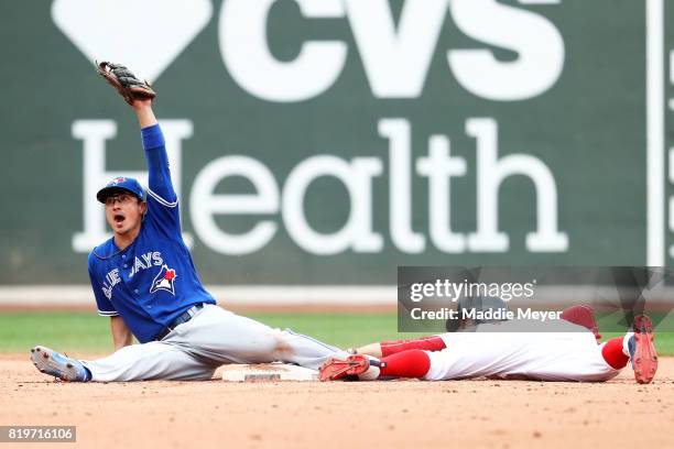 Darwin Barney of the Toronto Blue Jays tags out Mookie Betts of the Boston Red Sox as he tries to steal second during the fifth inning at Fenway Park...
