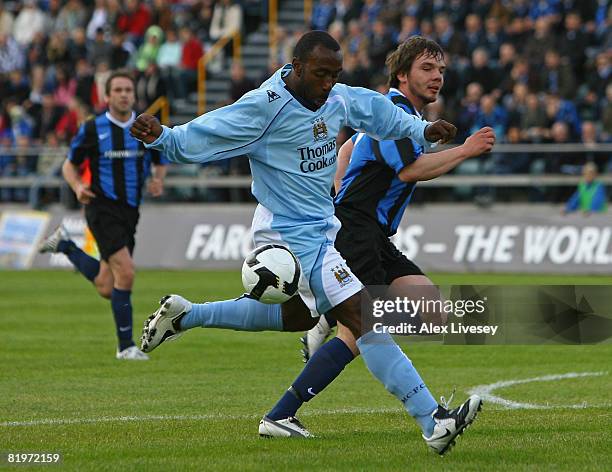Darius Vassell of Manchester City is challenged by Marni Djurhuus of EB/Streymur during the UEFA Cup 1st Round 1st Leg Qualifying match between...