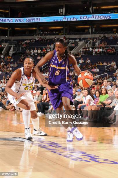 Delisha Milton Jones of the Los Angeles Sparks drives against Le'coe Willingham of the Phoenix Mercury on July 17 at U.S. Airways Center in Phoenix,...