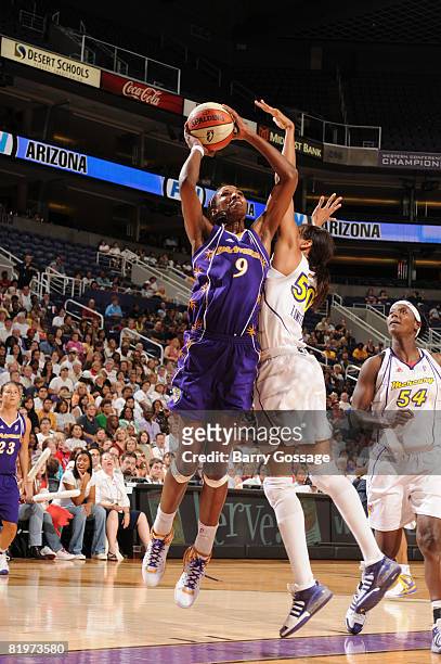 Lisa Leslie of the Los Angeles Sparks shoots against Tangela Smith of the Phoenix Mercury on July 17 at U.S. Airways Center in Phoenix, Arizona. NOTE...