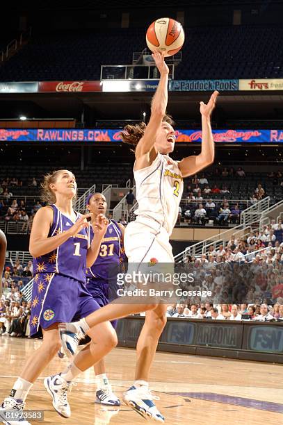 Kelly Miller of the Phoenix Mercury shoots against Sidney Spencer of the Los Angeles Sparks on July 17 at U.S. Airways Center in Phoenix, Arizona....