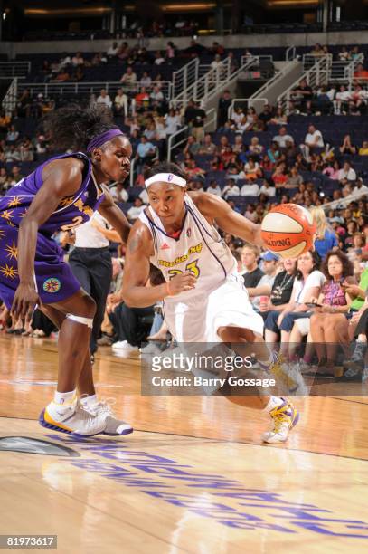 Cappie Pondexter of the Phoenix Mercury drives against Marie Ferdinand Harris of the Los Angeles Sparks on July 17 at U.S. Airways Center in Phoenix,...