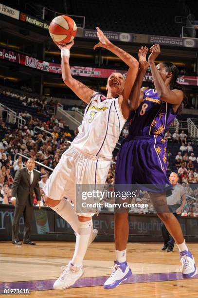 Diana Taurasi of the Phoenix Mercury shoots against Delisha Milton Jones of the Los Angeles Sparks on July 17 at U.S. Airways Center in Phoenix,...