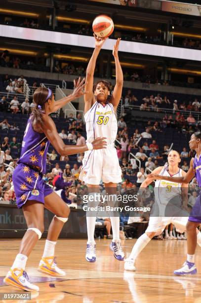 Tangela Smith of the Phoenix Mercury shoots against Lisa Leslie of the Los Angeles Sparks on July 17 at U.S. Airways Center in Phoenix, Arizona. NOTE...