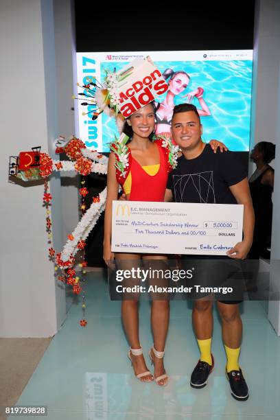 Model poses with Miami international University of Art and Design Fashion Student Pablo Machado Palomeque, winner of the McDCouture Design Challenge...