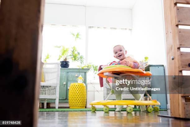 baby girl playing in walker - baby walker stock pictures, royalty-free photos & images